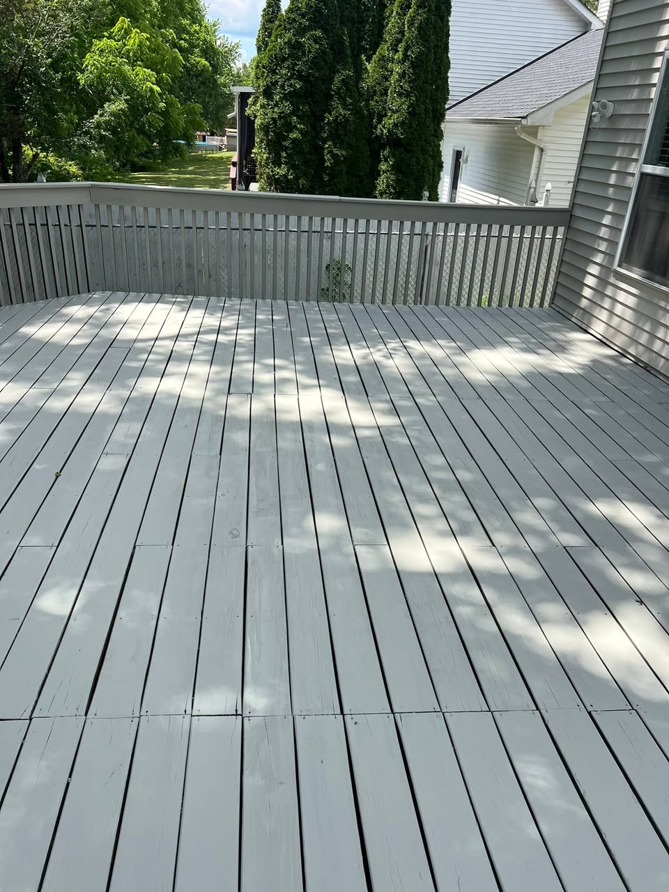 Fully restored wooden deck, refinished with a clean modern gray
